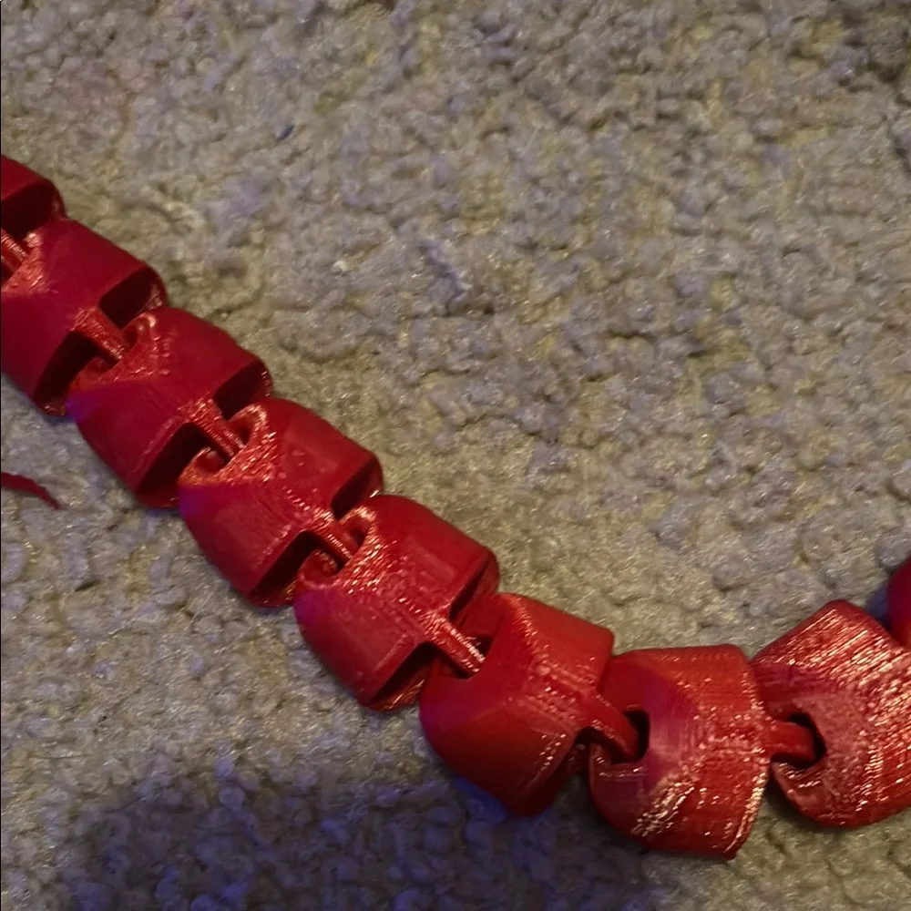 Red 3d printed snake with cowboy hat